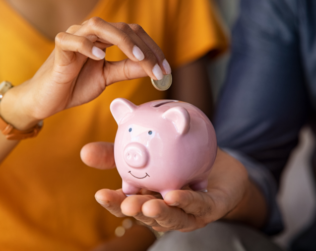 A person putting a coin into a savings bank, from the Boss Mortgage image library