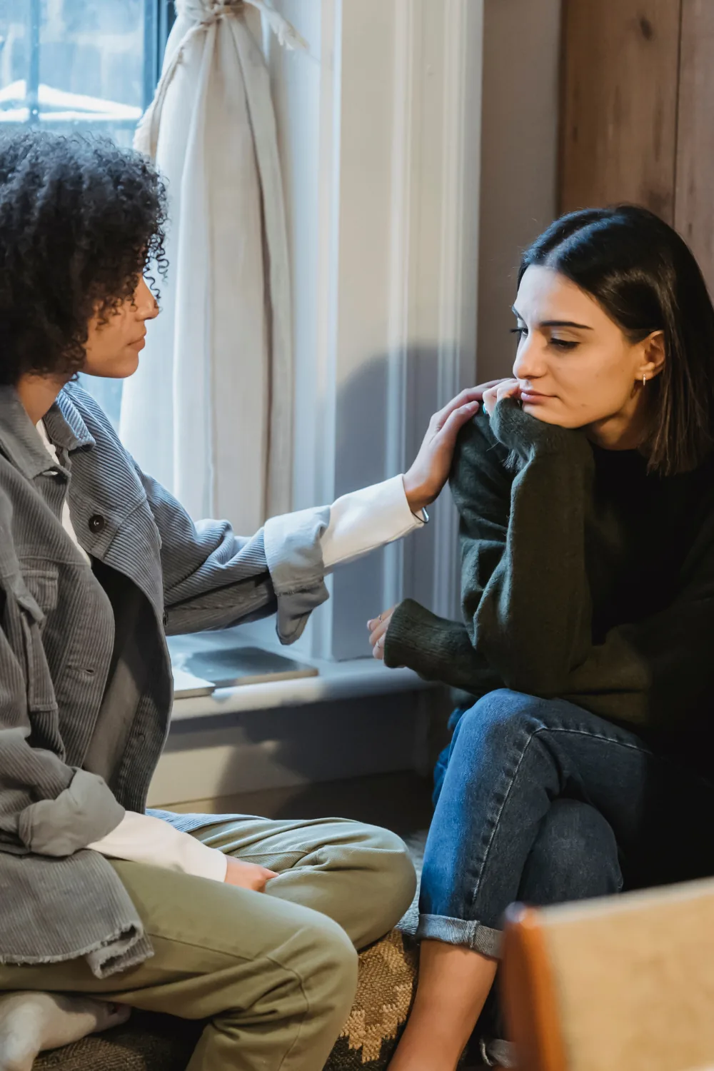 Two people talking on the steps of a home, from the Boss Mortgage image library