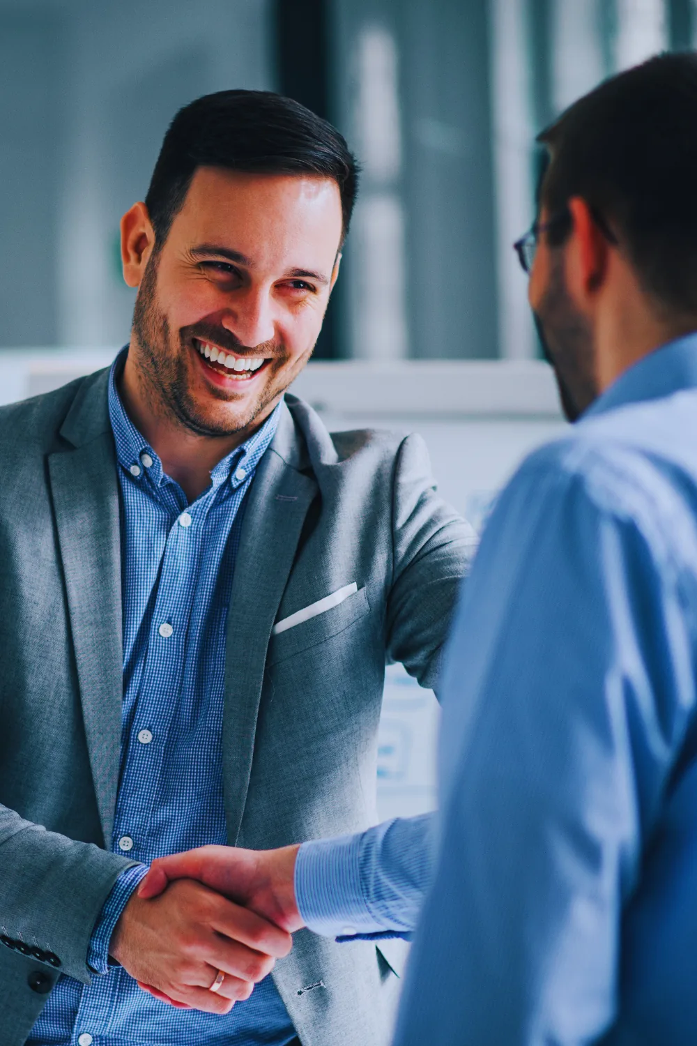 A borrower shaking hands with an advisor, from the Boss Mortgage image library